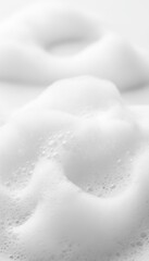 White Soap Foam Bubbles Texture Background. Macro view of soft soapy water from shampoo or detergent for hygiene. Abstract beauty spa pattern with fresh air suds on wet cosmetic liquid.