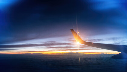 Wing at sunset through the window