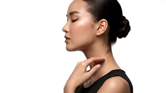 Profile of a woman's face and neck, hand gently touching throat
