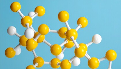 Hydrocarbon molecular model with yellow carbon atoms and white hydrogen atoms on light blue background.