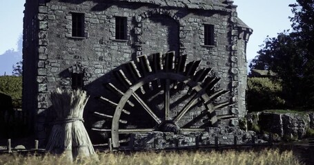 A large watermill featuring an impressive wooden wheel stands amidst lush green fields and distant mountains. The structure showcases stone craftsmanship and agricultural scenery.