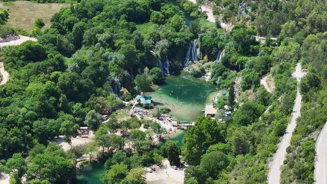 Drone view of a green oasis at Kravica with river flow waterfall cascades and dense vegetation