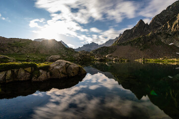 Surreal moonlit night landscape of Lago del Claus with mountain reflections, Alpi Marittime.