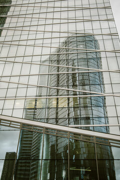 La Defense Paris modern corporate finance skyscraper architecture facade glass reflection on highrise office building downtown urban district perspective