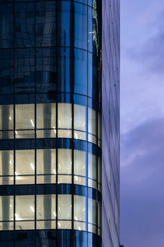 La Defense Paris corporate finance tower architecture with glass dusk lights shaping skyline above modern office headquarters evening cityscape windows glow