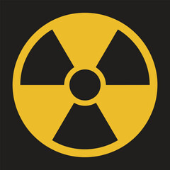 Fototapeta premium A bold yellow radioactive hazard symbol with three outward pointing blades inside a circle against a stark dark background