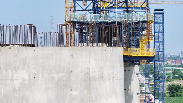 High-rise building construction site featuring a climbing formwork system in operation