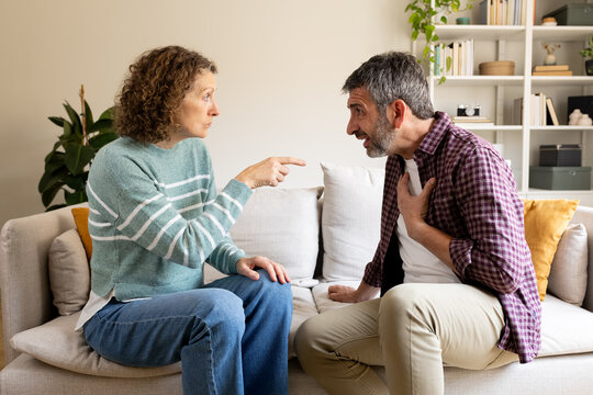 Couple having conflict, woman blaming man, relationship problems