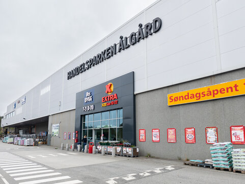 1 august 2025, Fiske, Norway. Facade and entrance of Trade Park &Aring;lg&aring;rd in Norway. Wooden planters at the entrance, promotional posters on the wall. Potting soil on pallets. Distribution industry.