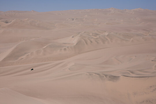 Sand dunes and dune buggy in Huacachina, Peru