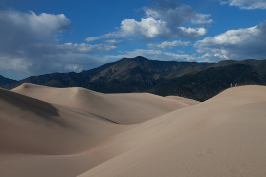 Couple hiking on the sand dunes at Great Sand Dunes National Park, CO