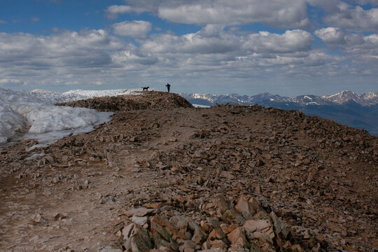 A man and his dog at the summit of  Mt Sherman near Leadville, CO