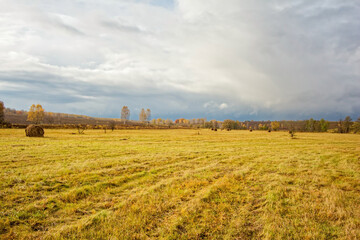 A mown field in late autumn on a cloudy day