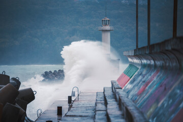 Stormy Huge Waves Breaks Against Sea Port Pier and Lighthouse coast of Varna City Bulgaria
