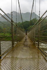 Fototapeta premium Bridge over a river with a foggy sky in the background