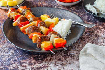 Beef meatballs kebab skewers glazed with sweet and sour sauce