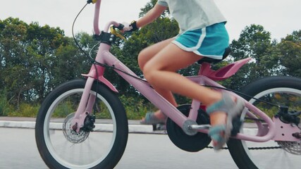 Girl learns cycling on the safety street with no traffic