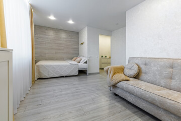 Open plan studio apartment interior with living and sleeping areas