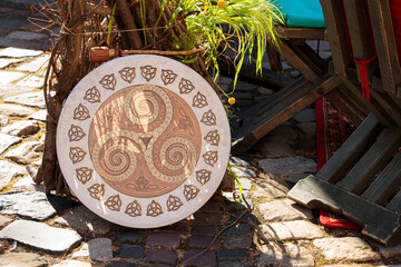 pagan cultural national acoustic drum music instrument urban cobble stone environment sunny place