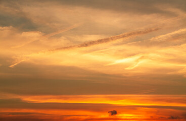 Beautiful bright orange sunset sky with clouds.