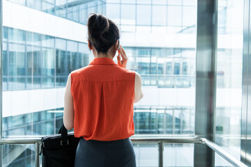 Businesswoman using mobile phone in the elevator © xy