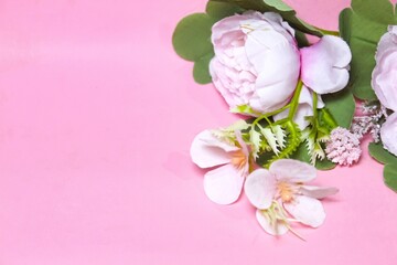Pink artificial flower composition. Pink background. Negative space.