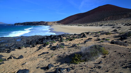 The picturesque sandy beach Playa de las Conchas in La Graciosa, Lanzarote, Canary Islands, Spain, with the volcano Montana Bermeja on the right © Christophe Cappelli
