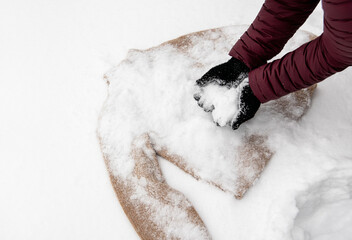 Giving a hand-knit wool garment a snow bath — a traditional way to clean natural knitted clothes....