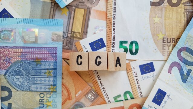 CGA acronym made of wooden letter cubes on pile of Euro banknotes. Caixa Geral de Aposenta&ccedil;oes (General Pension Fund)