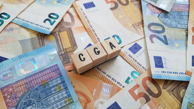 CGA acronym made of wooden letter cubes on pile of Euro banknotes. Caixa Geral de Aposenta&ccedil;oes (General Pension Fund)
