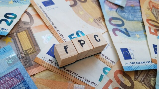 FPC acronym made of wooden letter cubes on pile of Euro banknotes. Fundo de Pensoes de Carreira (Career Pension Fund)