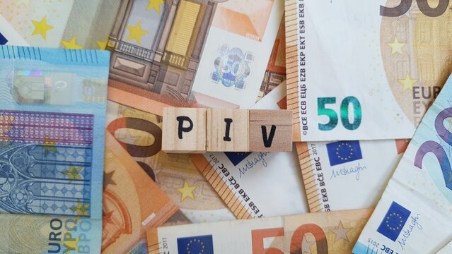 PIV acronym made of wooden letter cubes on pile of Euro banknotes. Plano de Investimentos de Vida (Life Investment Plan)