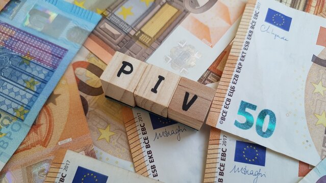 PIV acronym made of wooden letter cubes on pile of Euro banknotes. Plano de Investimentos de Vida (Life Investment Plan)