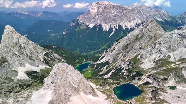 Aerial drone view of the Alps and the green Drachensee and Seebensee on a sunny summer day.	
