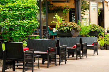 restaurant terrace outdoor clean calm street patio space seats furniture place chairs and tables in green plants environment floral
