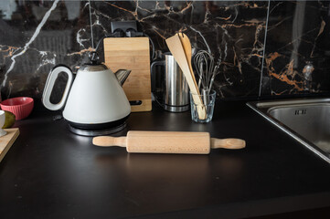 A wooden rolling pin on a table in the kitchen