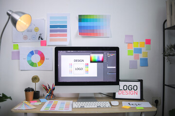 Modern Graphic Design Workspace With Computer Showing Logo Concept Color Wheels