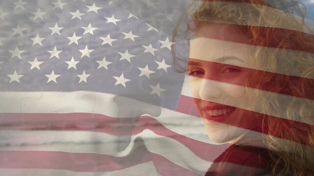 Animation of flag of united states of america over happy african american man on beach