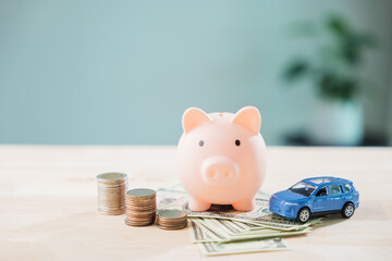 Piggy bank with car helps save money for auto insurance and fuel cost, refinance loan or finance drive and gas for transportation needs monthly budget planning with savings