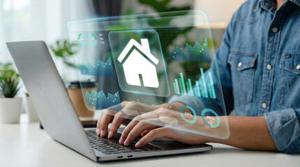 Business professional using laptop with futuristic real estate data interface