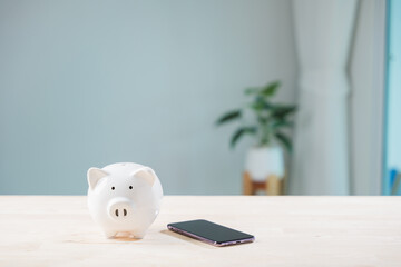 Digital savings mobile payment bank piggy phone online save smartphone pig app on wood table illustrates finance management using secure payment electronic banking software service