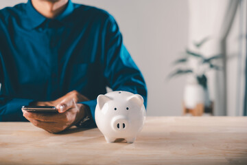 Person uses smartphone app for digital savings mobile payment, managing bank finances and planning economic growth, white pig bank symbolizes traditional and modern saving methods for future security