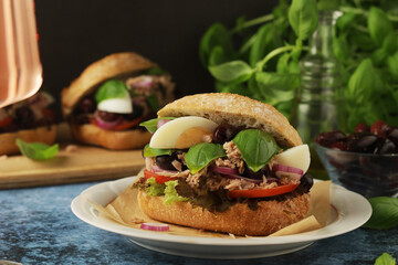 Traditional French sandwiches Pan Bagnat with tuna and salad niсoise
