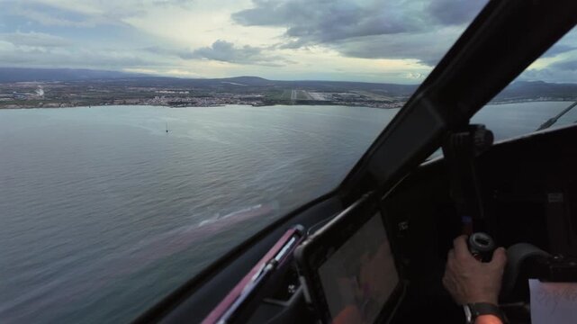 A real time immersive approach as seen by the pilot of the final approach to Palma de Mallrca (PMI) airport runway (RWY 06L) in the Blue Hour with a Clouded sky. Wiew of the pilot&rsquo;s hand