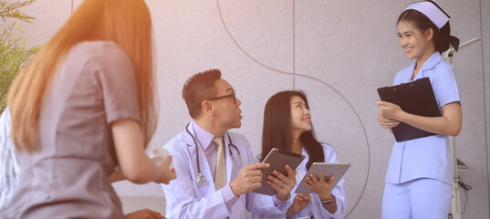 Male and female doctors are discussing checking a patient's temperature at the clinic.	