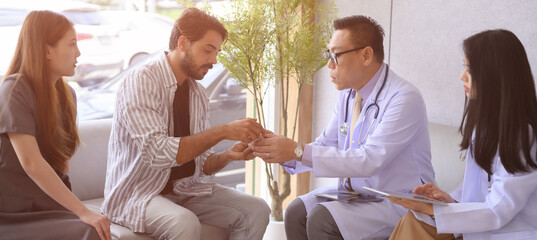 Male and female doctors are discussing checking a patient's temperature at the clinic.	