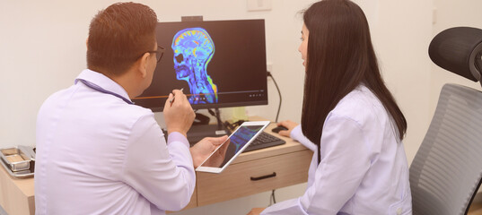Male and female doctors are discussing checking a patient's temperature at the clinic.