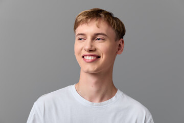 Smiling man in a casual white tee, headshot style with a relaxed expression, clean studio backdrop, friendly vibe and natural light, suitable for lifestyle, wellness, and positive messaging campaigns