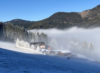 Winter Chalet in frosty snow with blue sky with mountain, Stuhleck, Austria Alps