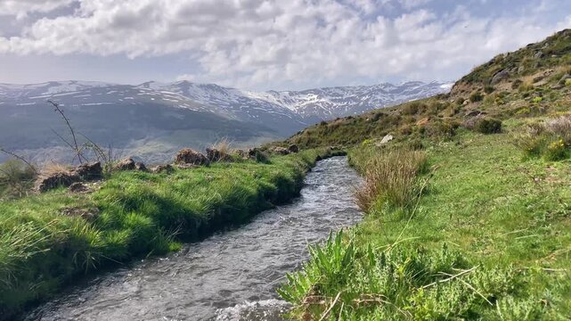 Water stream flowing from melting snow in the spring, Sierra Nevada range, Andalusia, Spain